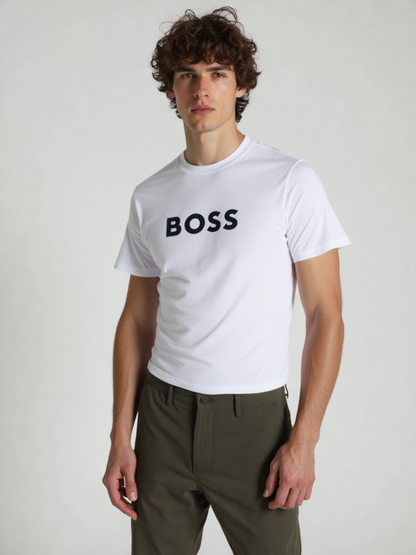Person wearing a white 'BOSS' t-shirt and green pants on a plain background